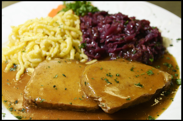 Tender Pork Loin slowly oven roasted in Dark Beer and Vegetables served with Spätzle and Red Cabbage